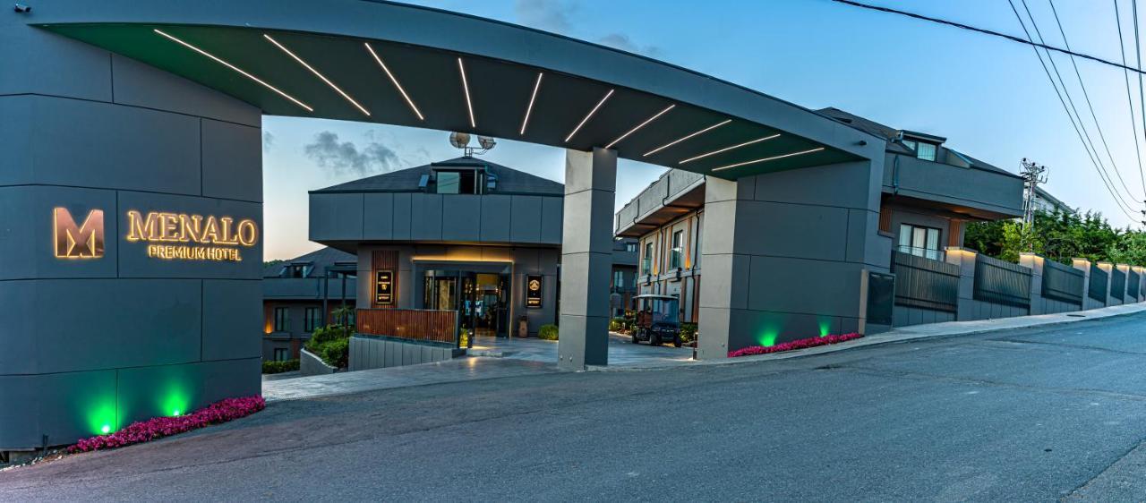 Menalo Hotel Premium Istanbul Airport Exterior photo The photo shows a modern building entrance with an architectural canopy overhead. The structure has a sleek, contemporary design with a mix of materials, likely metal and glass. It features a welcoming entrance that leads into the interior of the bui